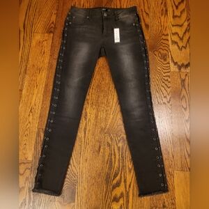 Women's Romeo + Juliet Couture jeans with metal grommet detailing